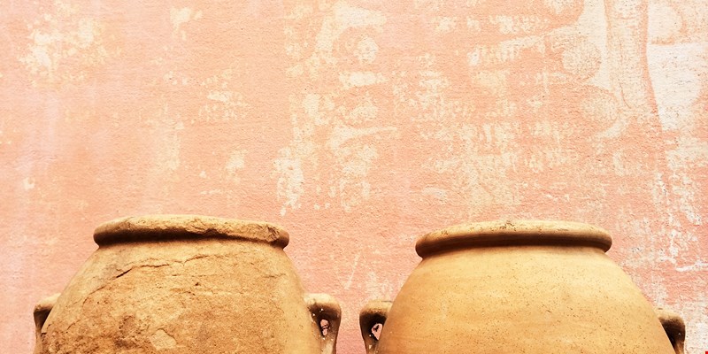 Clay amphoras near an old wall, traditional craft.